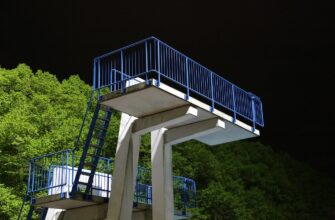 outdoor pool, diving platform, night