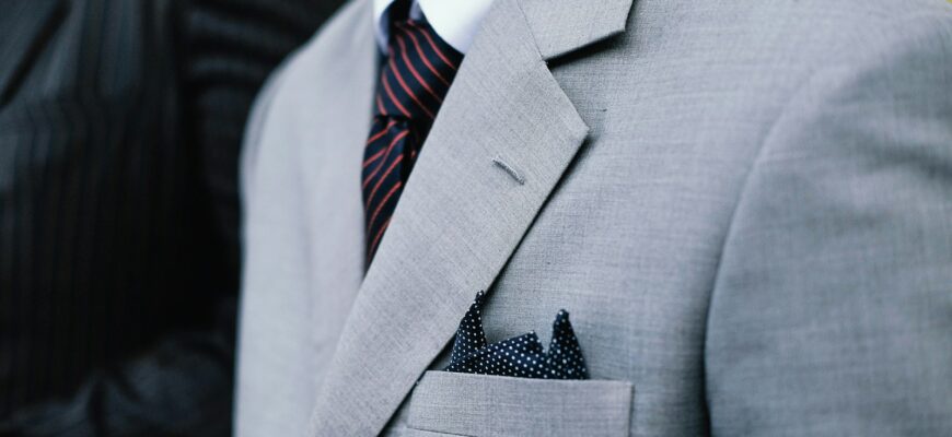 man wearing gray notched lapel suit jacket standing