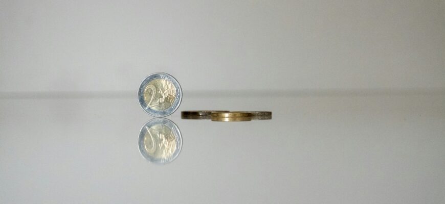 a gold ring with a coin on top of it