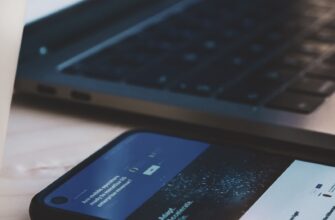black android smartphone beside black laptop computer